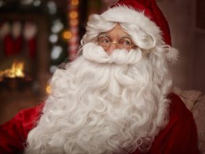 Santa claus warming up next to the fireplace 1